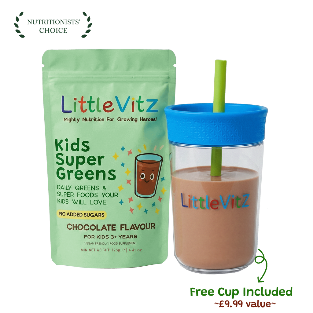 LittleVitz Kids Super Greens chocolate flavour powder pouch shown next to a clear plastic cup with a bright blue lid and straw, filled with the prepared drink. The packaging features a light green background with colorful text and graphics.