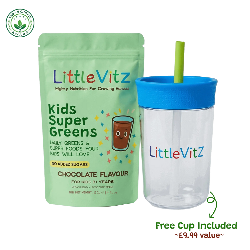 LittleVitz Kids Super Greens chocolate flavour food supplement pouch shown next to a free clear plastic travel tumbler with a blue lid and green straw, on a white background with a small award badge and 'Free Cup Included' text.