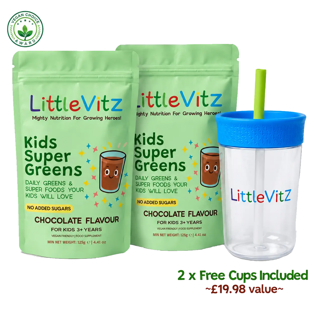 Two LittleVitz Kids Super Greens chocolate flavour pouches shown with two free cups included: one clear cup with a blue lid and green straw, and one blue tumbler with a clear lid. The background is white with a small green organic certification logo in the top left and text reading '2 x Free Cups Included ~£19.